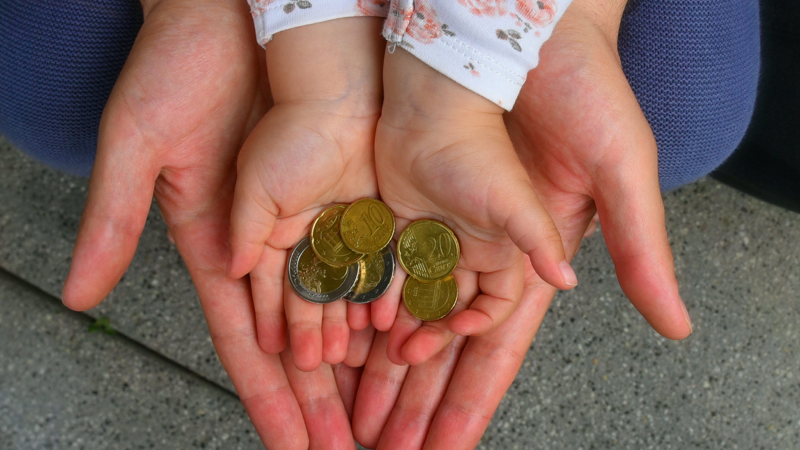 a father and his child with coins in their hands